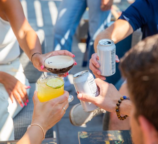 people toasting drinks and cocktails during happy hour